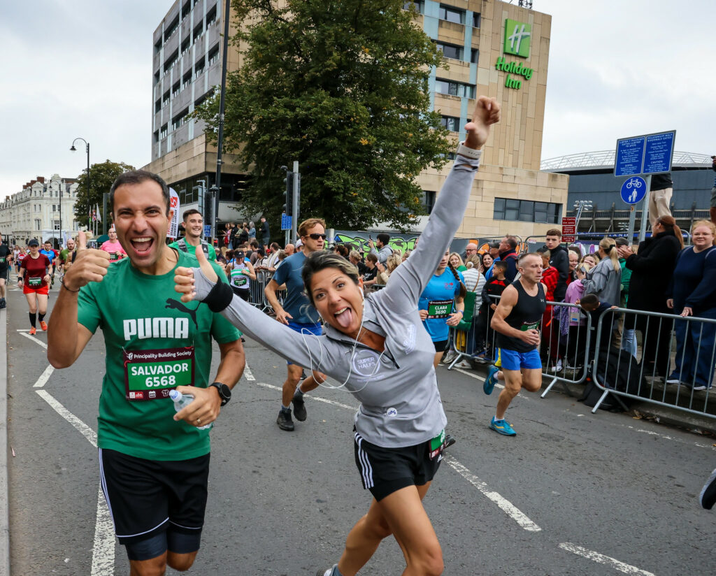 Two happy runners smiling at the camera