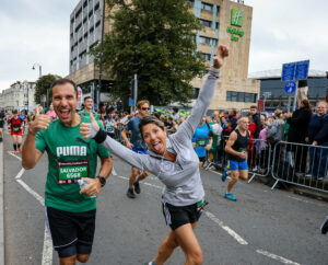 Two happy runners smiling at the camera