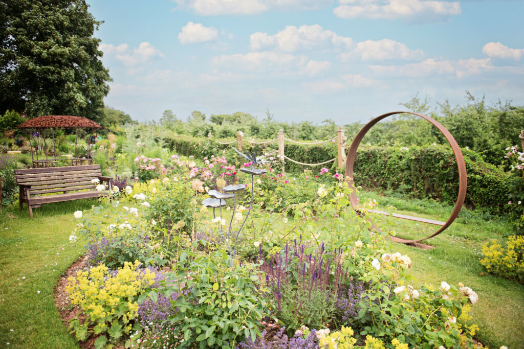 A serene garden with a swing and a bench, offering a peaceful spot for relaxation and enjoyment.