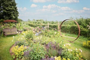 A serene garden with a swing and a bench, offering a peaceful spot for relaxation and enjoyment.