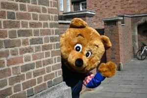 Benny Bear peaking around a wall