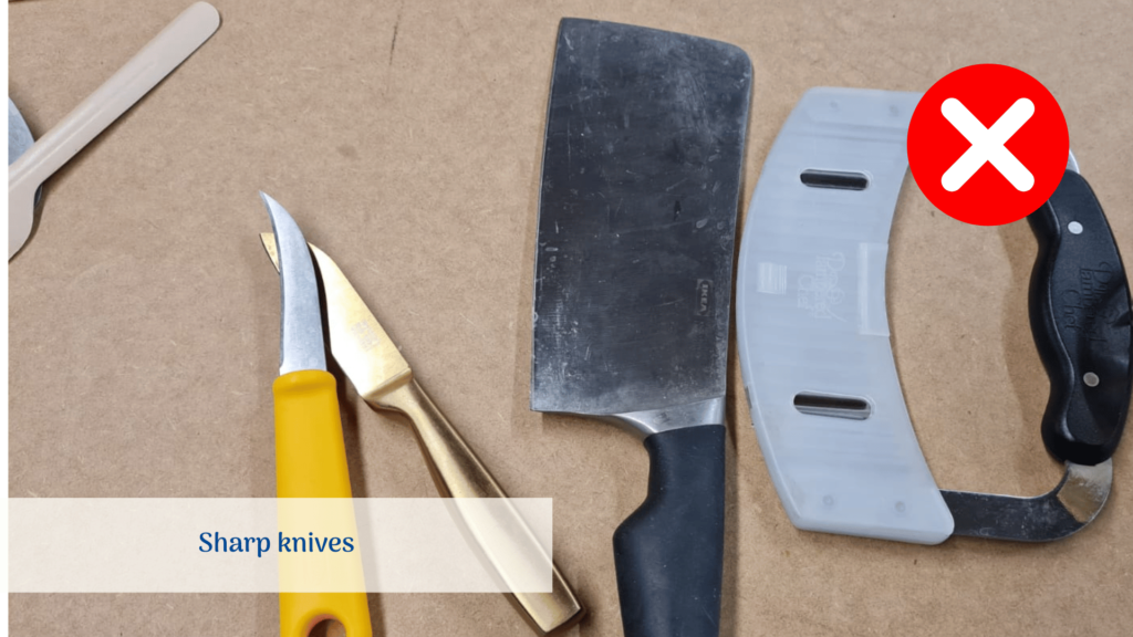 two small sharp kitchen knives, a meat cleaver and other chopping tool that were donated.